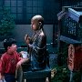Japan - Tokyo -. Boy at statue of Buddha at Asakasa Temple.