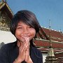 Thailand - Bangkok - Girl giving Wei and saying Sawadee-kaa (hello) at Grand Palace.