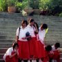 Chiang Mai, Thailand. Girls releasing fish at Ping River to gain favor in a future life.