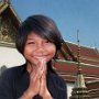 Bangkok, Thailand. Girl giving Wei and saying Sawadee-kaa (hello) at Grand Palace.