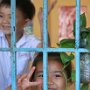 Vietnam - Saigon  school kids in window